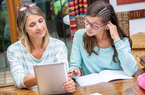 Image of an older woman teaching a girl