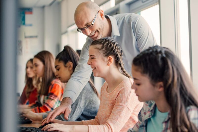 Professor helping a student with a lesson on the computer