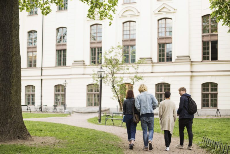 Group of students walk towards school