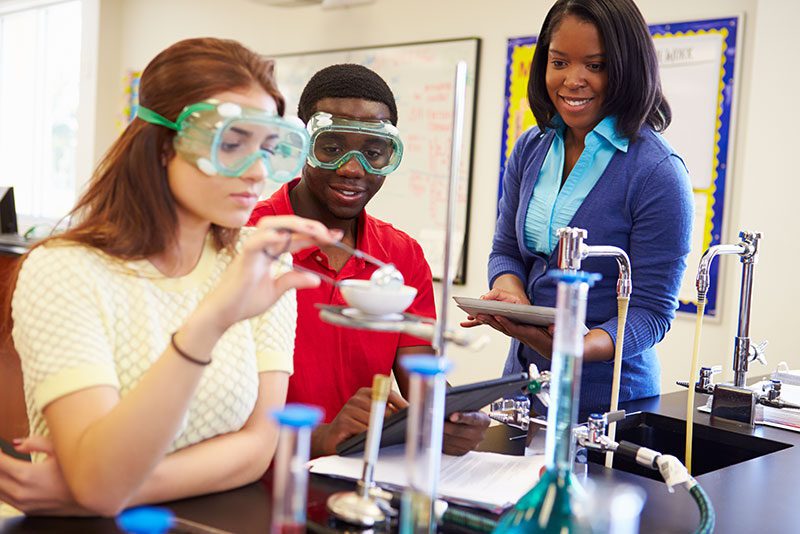 Two students performing science experiment