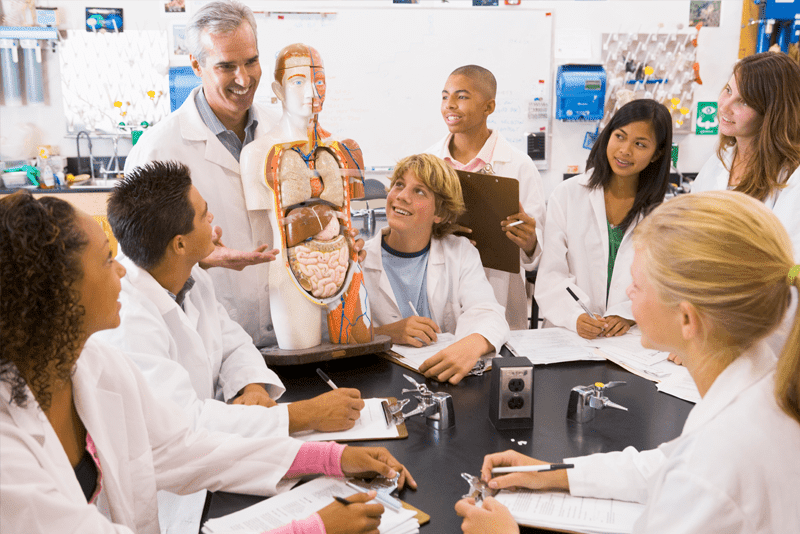 High school kids in biology classroom with teacher