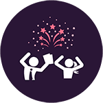 Two students celebrating under fireworks