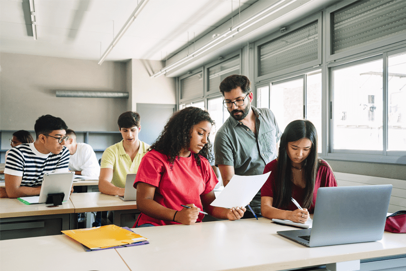 Teacher with students in a classroom