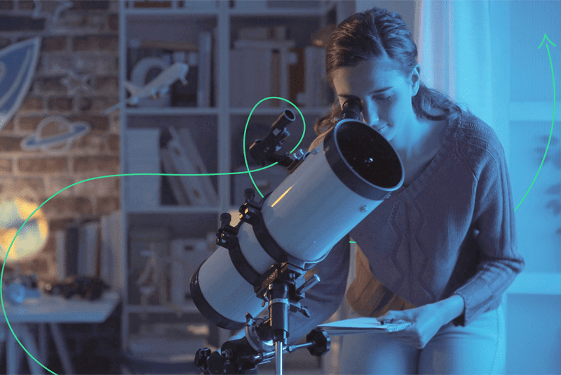 Girl looking through a telescope