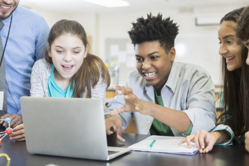 Students with teacher smiling